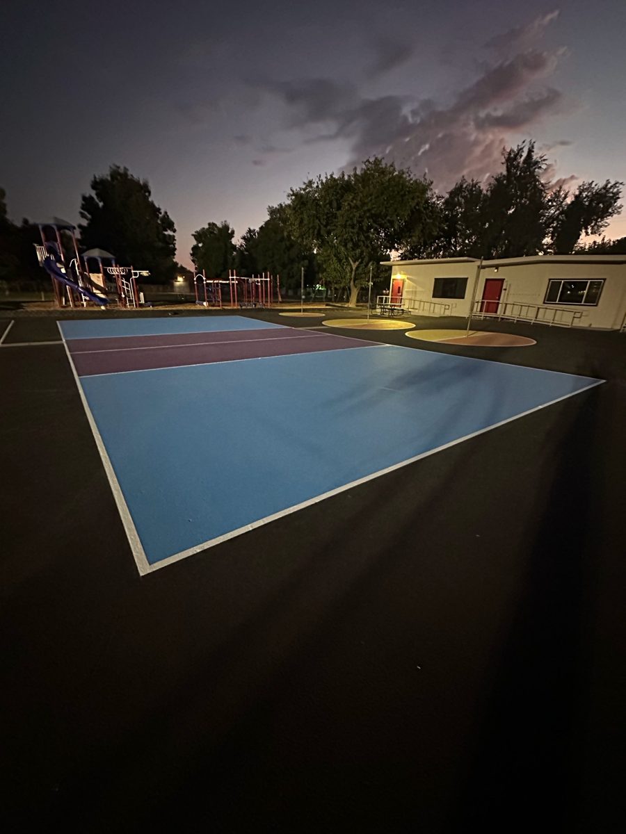 Pickleball and four-square courts at dusk